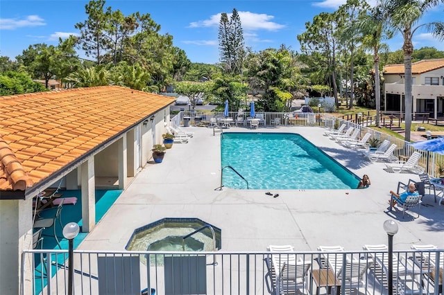 view of pool featuring a community hot tub and a patio