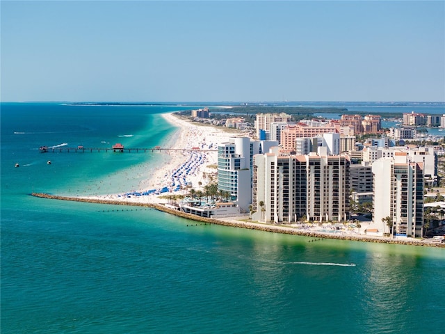 birds eye view of property featuring a water view and a beach view