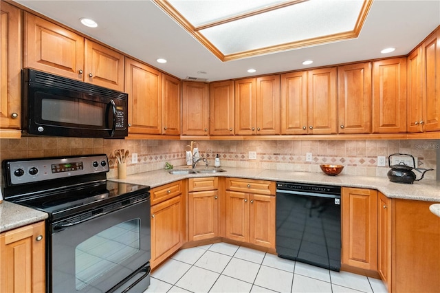 kitchen with light tile patterned floors, sink, light stone counters, and black appliances