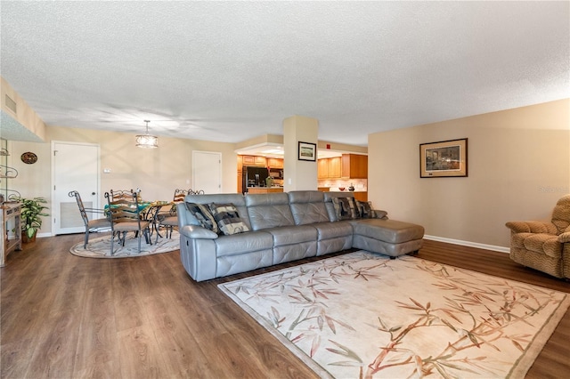 living room with hardwood / wood-style floors and a textured ceiling