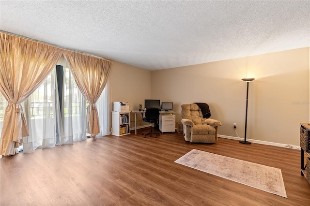 sitting room with wood-type flooring and a textured ceiling