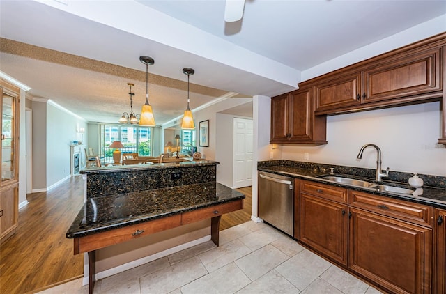 kitchen featuring dishwasher, sink, light hardwood / wood-style flooring, crown molding, and dark stone counters