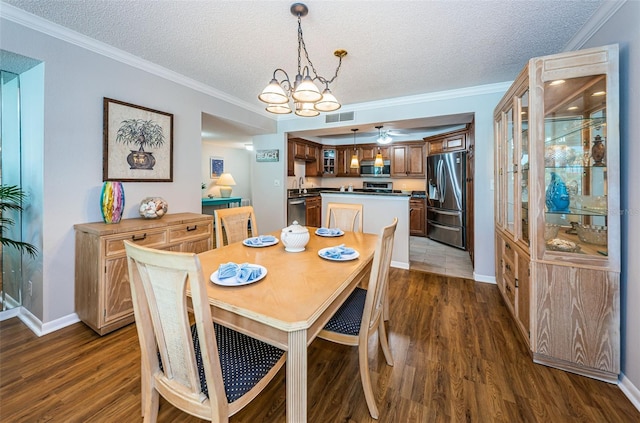 dining area with crown molding, dark hardwood / wood-style flooring, and a textured ceiling