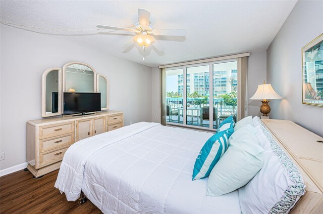 bedroom with ceiling fan, dark hardwood / wood-style floors, and access to outside