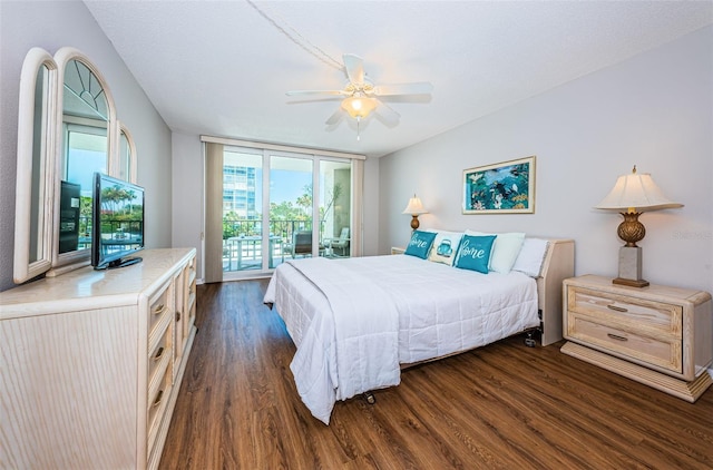 bedroom featuring dark hardwood / wood-style floors, ceiling fan, and access to outside