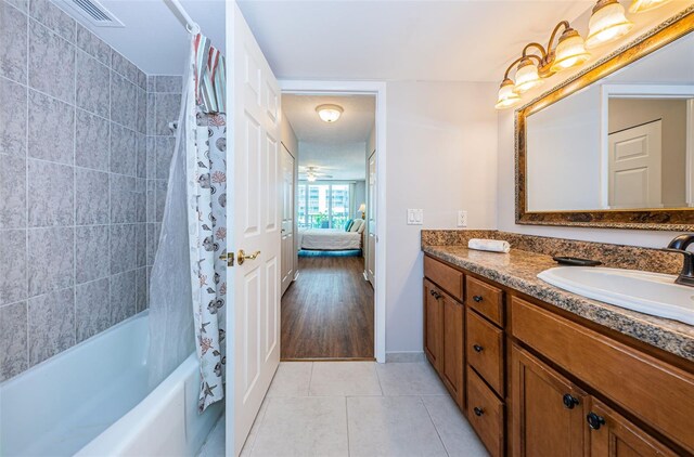 bathroom featuring vanity, ceiling fan, wood-type flooring, and shower / tub combo with curtain