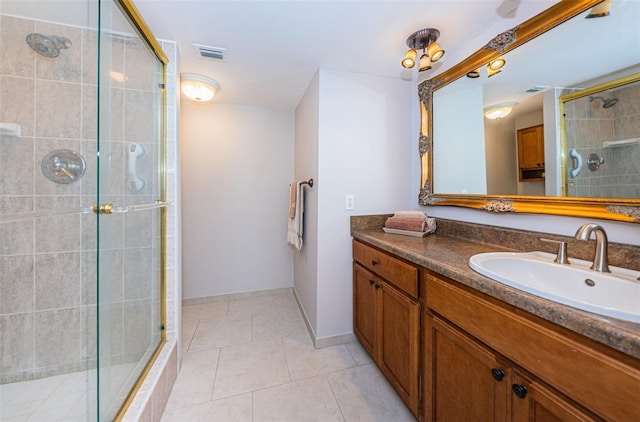 bathroom with tile patterned floors, vanity, and walk in shower