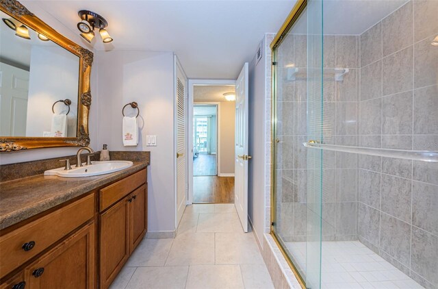 bathroom with vanity, tile patterned floors, and a shower with shower door