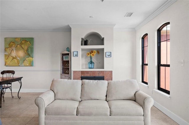 tiled living room with plenty of natural light, built in features, and ornamental molding