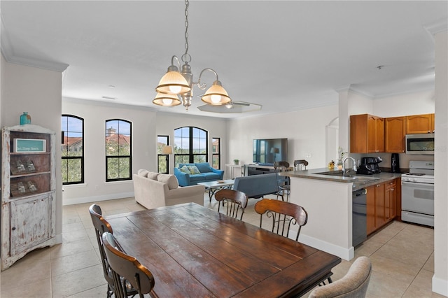 tiled dining space featuring sink, a chandelier, and crown molding