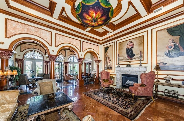 interior space with decorative columns, a fireplace, french doors, tile patterned floors, and ornamental molding