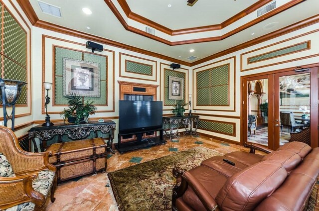 tiled living room featuring french doors, a raised ceiling, and ornamental molding