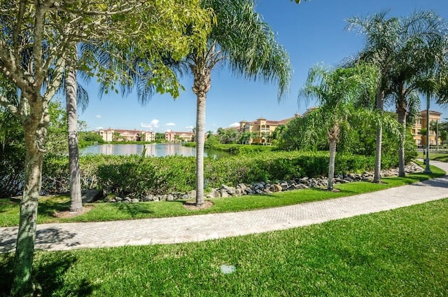 view of property's community featuring a yard and a water view