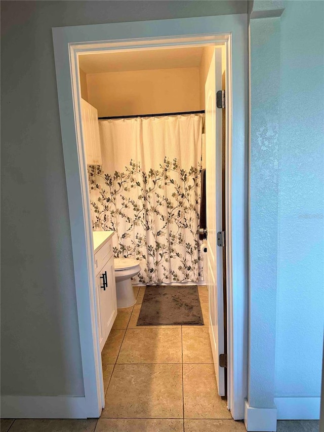 bathroom with vanity, tile patterned flooring, and toilet