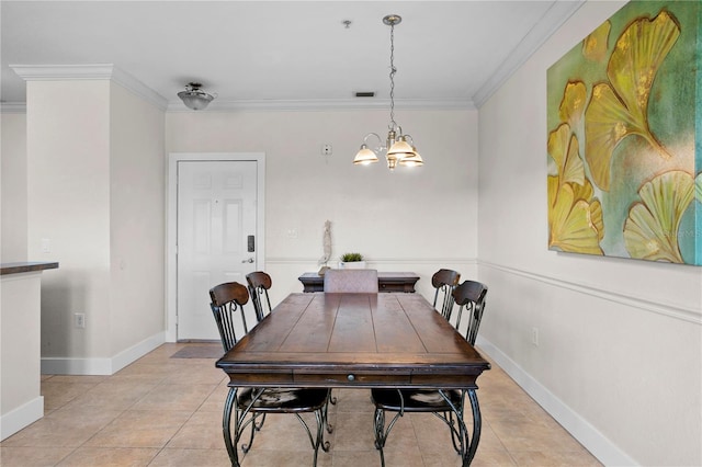 tiled dining room featuring a notable chandelier and ornamental molding