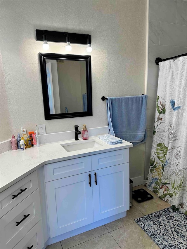 bathroom with vanity and tile patterned flooring