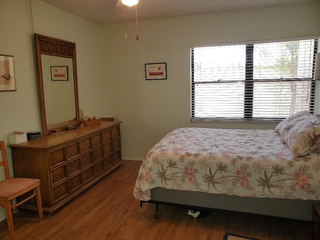 bedroom with hardwood / wood-style flooring and ceiling fan