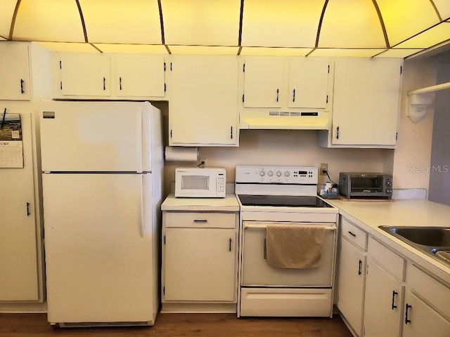 kitchen featuring white cabinets and white appliances