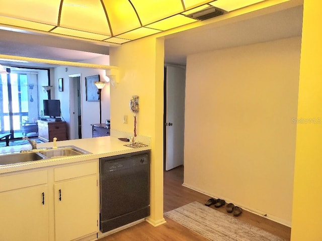 kitchen featuring white cabinets, light hardwood / wood-style floors, sink, and black dishwasher