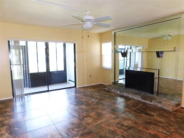 unfurnished living room featuring ceiling fan