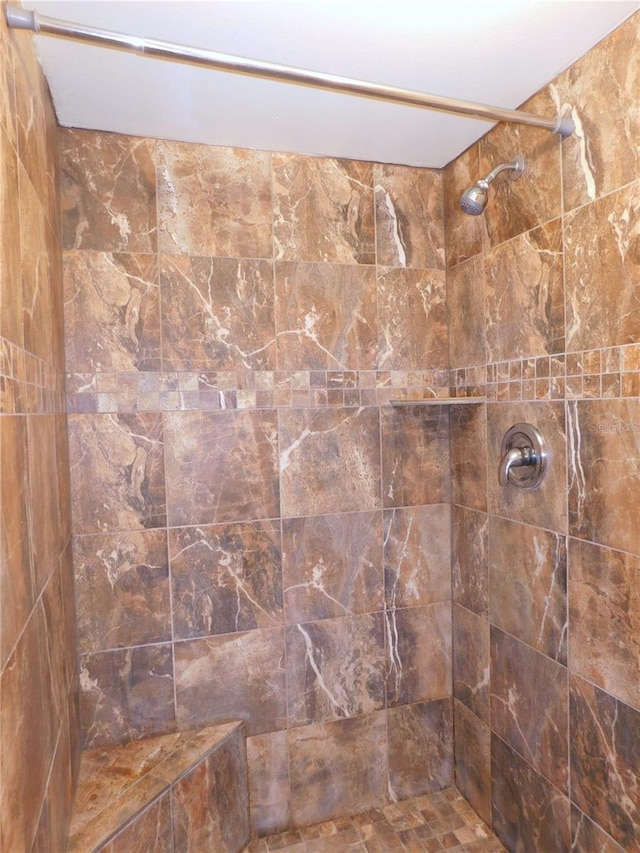 bathroom with a tile shower