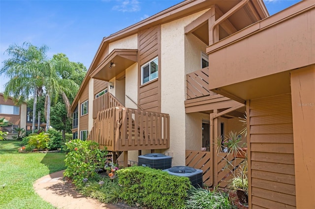 view of property exterior with a balcony and central air condition unit