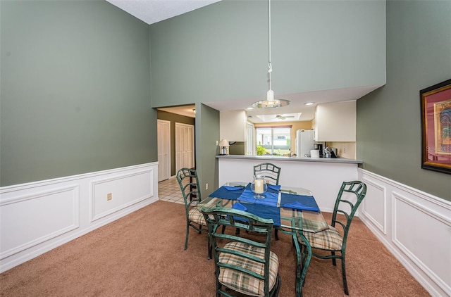 dining space with light colored carpet