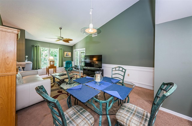 dining area featuring carpet flooring, vaulted ceiling, and ceiling fan