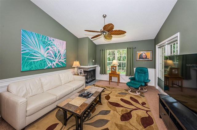 living room featuring carpet floors, ceiling fan, and lofted ceiling