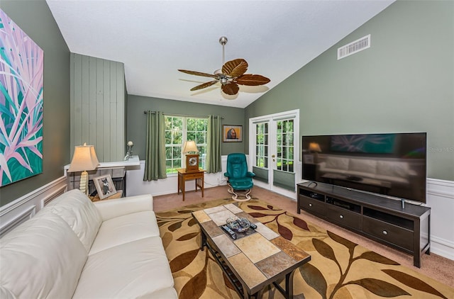 living room with ceiling fan, french doors, light colored carpet, and vaulted ceiling