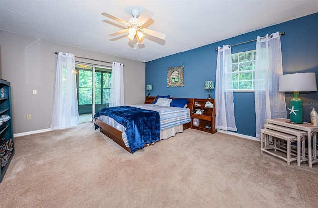 carpeted bedroom with multiple windows, ceiling fan, and a textured ceiling