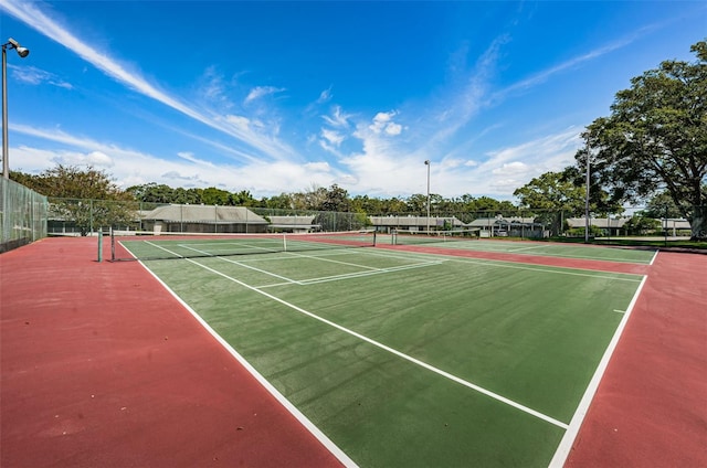 view of tennis court with basketball hoop