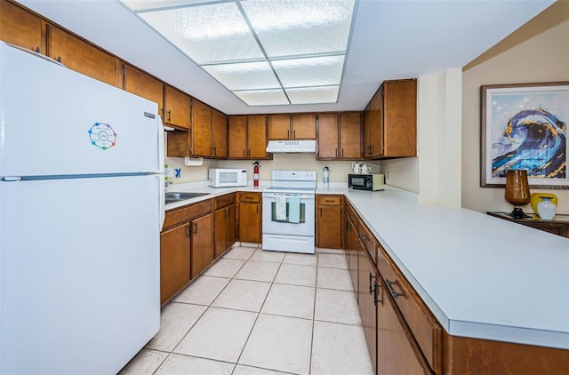 kitchen featuring kitchen peninsula, sink, light tile patterned flooring, and white appliances