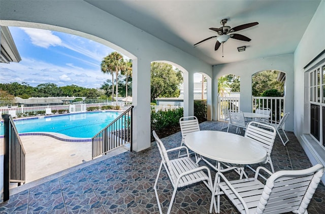 view of pool featuring ceiling fan and a patio area