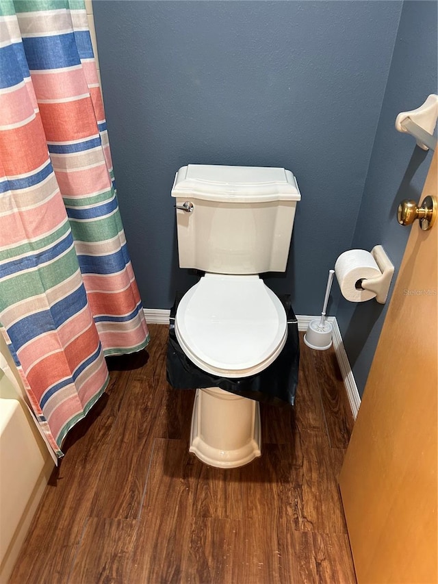 bathroom with hardwood / wood-style floors and toilet