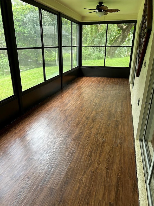 unfurnished sunroom with ceiling fan