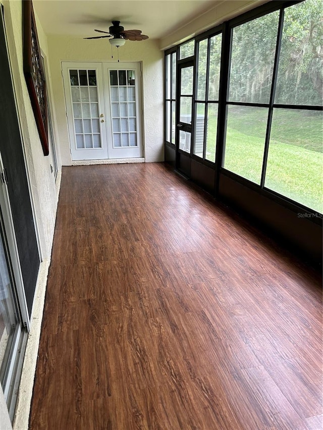 unfurnished sunroom with french doors, a wealth of natural light, and ceiling fan