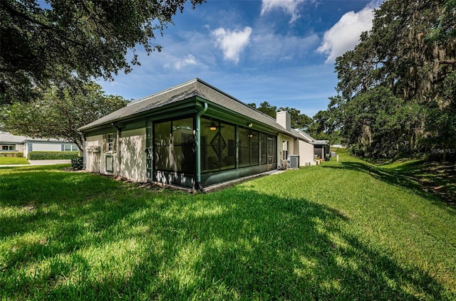 view of property exterior featuring a lawn and central AC