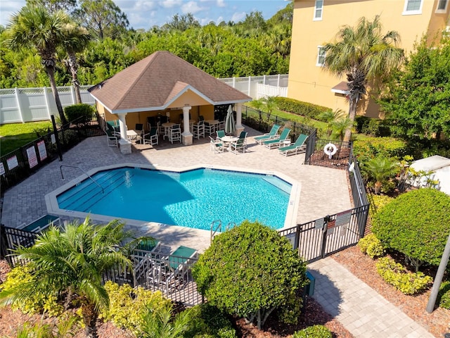 view of pool with an outbuilding and a patio