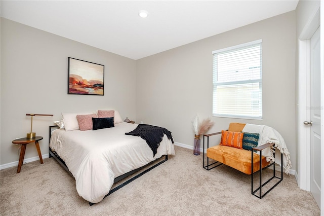 bedroom featuring light carpet