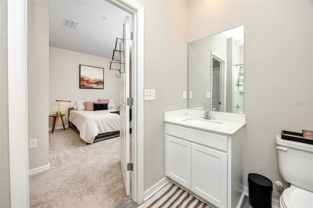 bathroom featuring vanity and toilet