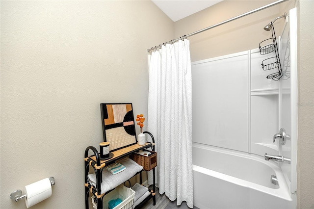 bathroom with shower / bath combo with shower curtain