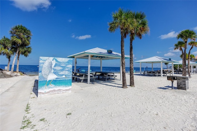 exterior space featuring a view of the beach, a gazebo, and a water view