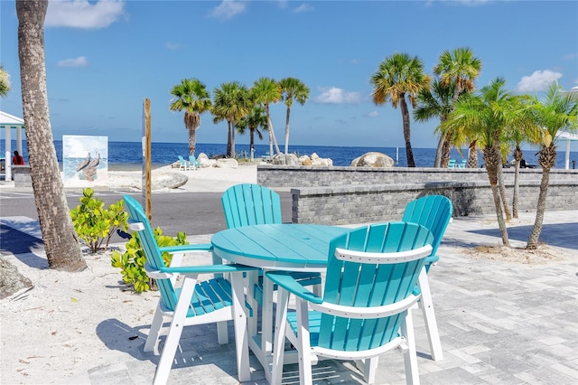 view of patio / terrace with a view of the beach and a water view