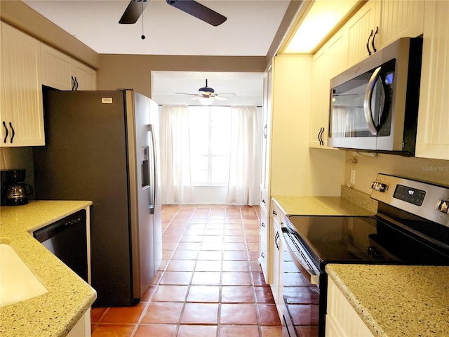 kitchen featuring white cabinetry, ceiling fan, light stone counters, light tile patterned flooring, and appliances with stainless steel finishes