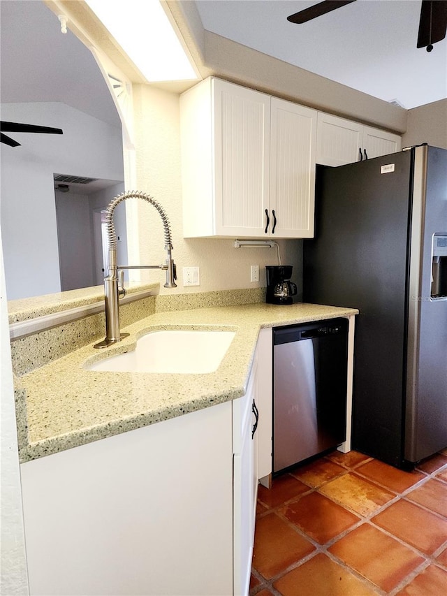 kitchen with white cabinets, sink, ceiling fan, light stone countertops, and appliances with stainless steel finishes