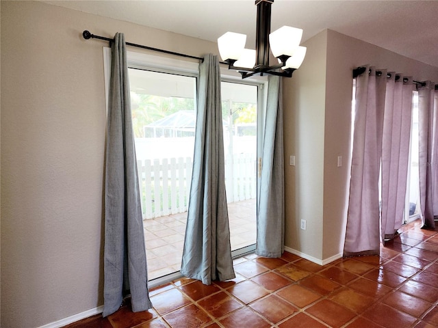 interior space with tile patterned flooring and an inviting chandelier