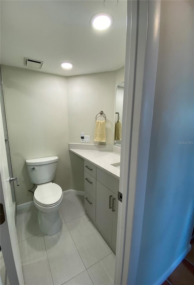 bathroom featuring tile patterned flooring, vanity, and toilet