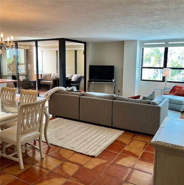 tiled living room with a textured ceiling and a chandelier