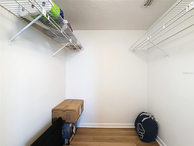 walk in closet featuring wood-type flooring